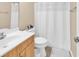 Bright bathroom featuring wood vanity, white fixtures, and shower with curtain at 1005 Kelly Ct., Garden City Beach, SC 29576