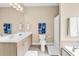 Bathroom featuring a white vanity, soaking tub, and decorative blue towels at 1005 Kelly Ct., Garden City Beach, SC 29576