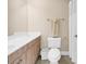 Bright bathroom features white vanity, white fixtures, and shower with curtain at 1005 Kelly Ct., Garden City Beach, SC 29576