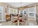 Sunlit dining room with decoratively set table, large windows and stylish furnishings at 1005 Kelly Ct., Garden City Beach, SC 29576