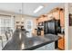 Kitchen with breakfast bar seating, black appliances and wood cabinets at 1005 Kelly Ct., Garden City Beach, SC 29576
