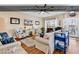 Main level living room is spacious, decorated with modern coastal decor and features a ceiling fan and natural light at 1005 Kelly Ct., Garden City Beach, SC 29576