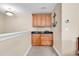 Upstairs wet bar features wood cabinets, granite counters, and carpeted floor at 1005 Kelly Ct., Garden City Beach, SC 29576