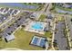 Aerial shot of a community pool area with tennis courts, shaded seating, and ample parking spaces at 1031 Cascade Loop, Little River, SC 29566