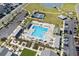 Aerial view of a community pool featuring sun loungers, umbrellas, a tennis court, and nearby parking at 1031 Cascade Loop, Little River, SC 29566