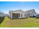 Backyard view with lawn and screened porch of the home, and neighboring homes at 1031 Cascade Loop, Little River, SC 29566