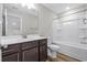 Full bathroom features a vanity with dark wood cabinets and a tub/shower combo at 1031 Cascade Loop, Little River, SC 29566