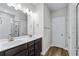 Bathroom featuring a double sink vanity with dark cabinets and a glass-enclosed shower at 1031 Cascade Loop, Little River, SC 29566