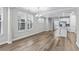 Bright dining area featuring wood floors, a modern chandelier, and access to an open-concept kitchen at 1031 Cascade Loop, Little River, SC 29566