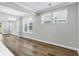Sunlit dining area features wood-look floors, large windows, and a modern chandelier, adjacent to the living spaces at 1031 Cascade Loop, Little River, SC 29566