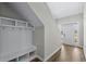 Bright entryway features a built-in mudroom bench and storage, with wood-look floors and a glass-paneled front door at 1031 Cascade Loop, Little River, SC 29566