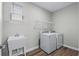 Bright laundry room with washer, dryer, sink, overhead rack and window at 1031 Cascade Loop, Little River, SC 29566