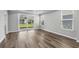 Bright living area featuring wood floors, recessed ceilings, and a sliding glass door leading to the backyard at 1031 Cascade Loop, Little River, SC 29566