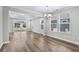 Inviting living area with tray ceilings, wood floors, and sliding glass doors to the backyard at 1031 Cascade Loop, Little River, SC 29566