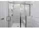 Glass-enclosed shower with white tile, bench seat, and bronze hardware at 1031 Cascade Loop, Little River, SC 29566