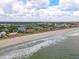 Expansive aerial view of a stunning coastline, showcasing pristine beaches, vibrant homes, and serene ocean waters at 109 Pioneer Loop, Georgetown, SC 29440