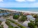 Stunning aerial view capturing a picturesque coastal neighborhood with beautiful homes, lush landscaping, and serene ocean vistas at 109 Pioneer Loop, Georgetown, SC 29440