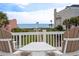 A delightful balcony view showcasing the ocean, American flag, and inviting outdoor seating for relaxation and enjoyment at 109 Pioneer Loop, Georgetown, SC 29440