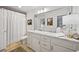 Well-lit bathroom with a shower, white vanity, marble countertop, and large mirror that enhances the sense of space at 109 Pioneer Loop, Georgetown, SC 29440