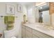Bathroom featuring a marble countertop, floral artwork, and a charming decorative mirror at 109 Pioneer Loop, Georgetown, SC 29440