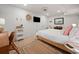 Bright bedroom featuring a TV, white linens, and a jute rug, creating a simple and inviting atmosphere for rest at 109 Pioneer Loop, Georgetown, SC 29440