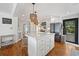 Modern kitchen featuring white cabinets, hardwood floors, marble countertops, and black appliances at 109 Pioneer Loop, Georgetown, SC 29440