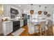 Modern kitchen featuring white cabinets, hardwood floors, marble countertops, and black appliances at 109 Pioneer Loop, Georgetown, SC 29440