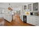 Modern kitchen featuring white cabinets, hardwood floors, marble countertops, and stainless steel appliances at 109 Pioneer Loop, Georgetown, SC 29440
