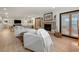 Spacious living room with hardwood floors, comfortable sofas, a modern fireplace, and a view of the backyard at 109 Pioneer Loop, Georgetown, SC 29440