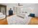 Bright main bedroom featuring hardwood floors, a ceiling fan, a decorative rug, and natural light from a window at 109 Pioneer Loop, Georgetown, SC 29440
