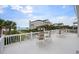 Expansive deck area with outdoor seating overlooking the ocean and large home at 109 Pioneer Loop, Georgetown, SC 29440
