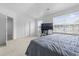 Bedroom with neutral carpeting, fresh white walls, a large window, and an open doorway at 109 Winding Path Dr., Loris, SC 29569
