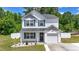 Charming two-story home features a well-manicured lawn and a classic white exterior with blue shutters at 109 Winding Path Dr., Loris, SC 29569