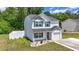 Charming two-story home with blue shutters, a well-kept lawn, an attached one-car garage, and a white picket fence at 109 Winding Path Dr., Loris, SC 29569