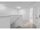 Hallway with neutral carpeting, fresh white walls, and a bright light streaming through the doorway at 109 Winding Path Dr., Loris, SC 29569