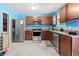 Kitchen featuring stainless steel appliances, wood cabinets and blue accent wall at 109 Winding Path Dr., Loris, SC 29569