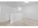 Bright loft area with neutral carpeting, fresh white walls, and natural light streaming through the windows at 109 Winding Path Dr., Loris, SC 29569