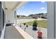 Inviting covered porch features decorative potted plants and a view of the quiet neighborhood street at 109 Winding Path Dr., Loris, SC 29569