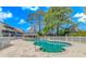 Inviting community pool surrounded by white picket fence, lush trees, and multiple seating areas at 1100 Possum Trot Rd. # H136, North Myrtle Beach, SC 29582