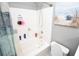 Bright bathroom featuring a shower-over-tub, white tiles, and coastal-themed wall art at 1101 Peace Pipe Pl. # 201, Myrtle Beach, SC 29579