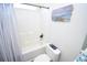 Clean bathroom featuring a shower-over-tub, white tiles, and beach-themed decor at 1101 Peace Pipe Pl. # 201, Myrtle Beach, SC 29579