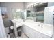 Bathroom with dual sinks, white cabinetry, and a large mirror at 1101 Peace Pipe Pl. # 201, Myrtle Beach, SC 29579