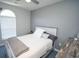Serene bedroom with a decorative window, soft linens, a ceiling fan and neutral color palette at 1101 Peace Pipe Pl. # 201, Myrtle Beach, SC 29579