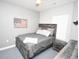 Cozy bedroom features a rustic wood bed frame, grey linens, and a decorative American flag at 1101 Peace Pipe Pl. # 201, Myrtle Beach, SC 29579