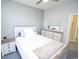 Bright bedroom featuring light wood furniture, plush bedding, and a ceiling fan at 1101 Peace Pipe Pl. # 201, Myrtle Beach, SC 29579