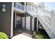 Apartment building exterior with staircase and patio at 1101 Peace Pipe Pl. # 201, Myrtle Beach, SC 29579