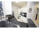Modern kitchen featuring dark granite countertops, white cabinets, and stainless steel appliances at 1101 Peace Pipe Pl. # 201, Myrtle Beach, SC 29579