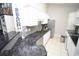 Open kitchen with granite counters, stainless appliances, and white cabinets at 1101 Peace Pipe Pl. # 201, Myrtle Beach, SC 29579