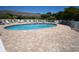 Community pool surrounded by ample seating and tables at 1101 Peace Pipe Pl. # 201, Myrtle Beach, SC 29579