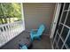 Cozy porch featuring a teal Adirondack chair and an outdoor cooler at 1101 Peace Pipe Pl. # 201, Myrtle Beach, SC 29579